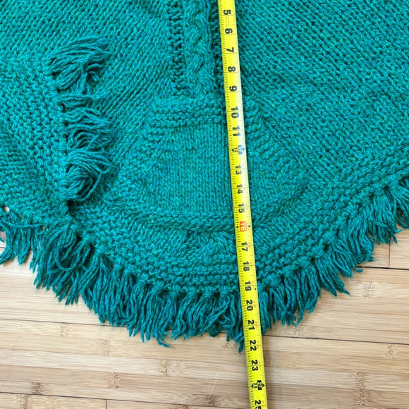 Hand knit fringed girl’s poncho. Cables centered on front and back, front pouch. - Picture 7 of 8